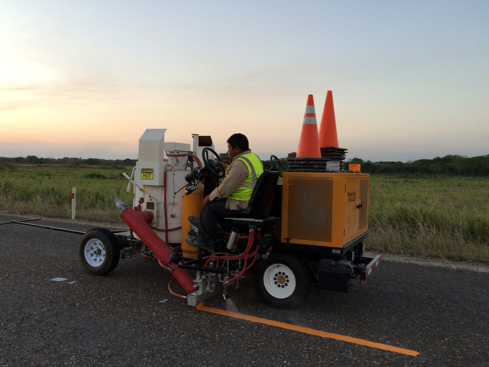 Máquina de rayado aplicando pintura termoplástica en carretera