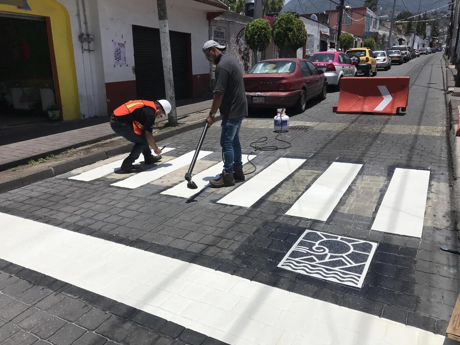 Cuadrilla colocando paso peatonal con figura de termoplástico preformado